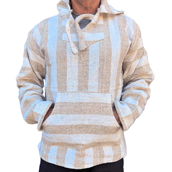 Person wearing a beige and white patterned sweater against a metallic background